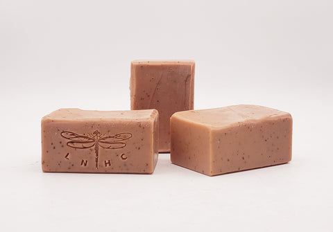 Pink handmade soap bars with dragonfly imprints.