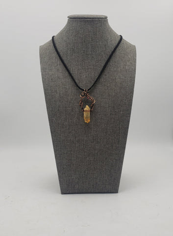 Crystal pendant necklace with intricate wire wrapping and a black cord.