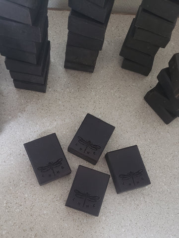 Black rectangular blocks with a dragonfly logo engraved on them.