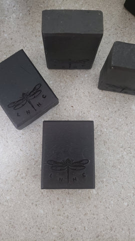 Black rectangular blocks with a dragonfly logo engraved on them.