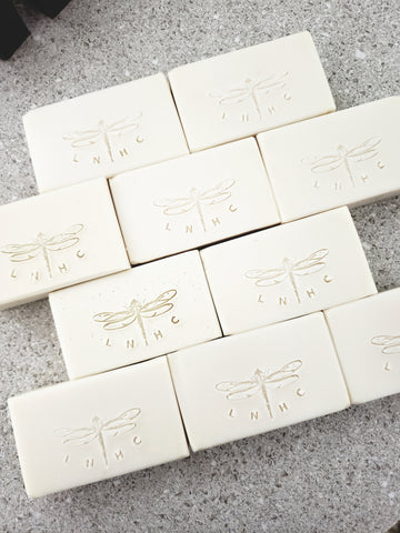 White soap bars with embossed dragonfly designs 