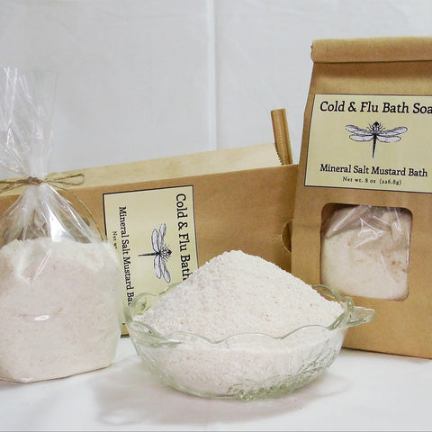 Cold & flu bath soak products in kraft paper packaging with mineral salt and mustard bath ingredients.