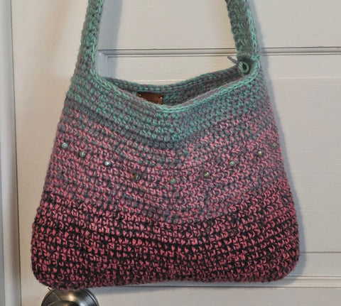 Crocheted shoulder bag with an ombre effect from mint green to pink.