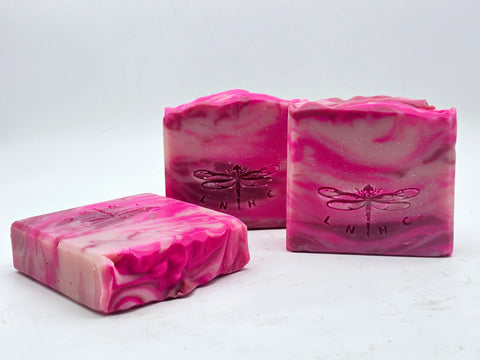 Pink marbled soap bars with dragonfly imprints.