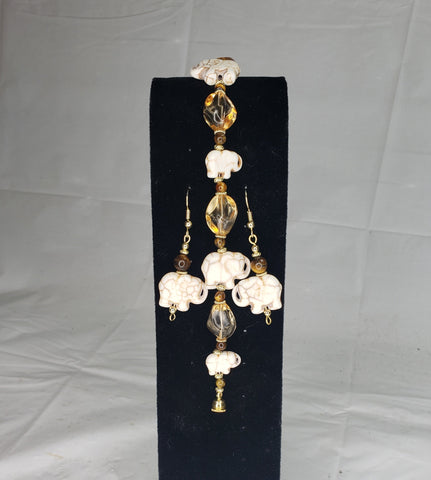 Handcrafted jewelry set featuring white elephant-shaped beads and amber-colored crystal accents.